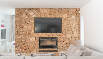 Resa estate modern villa for sale ibiza first line north stone wall.jpg